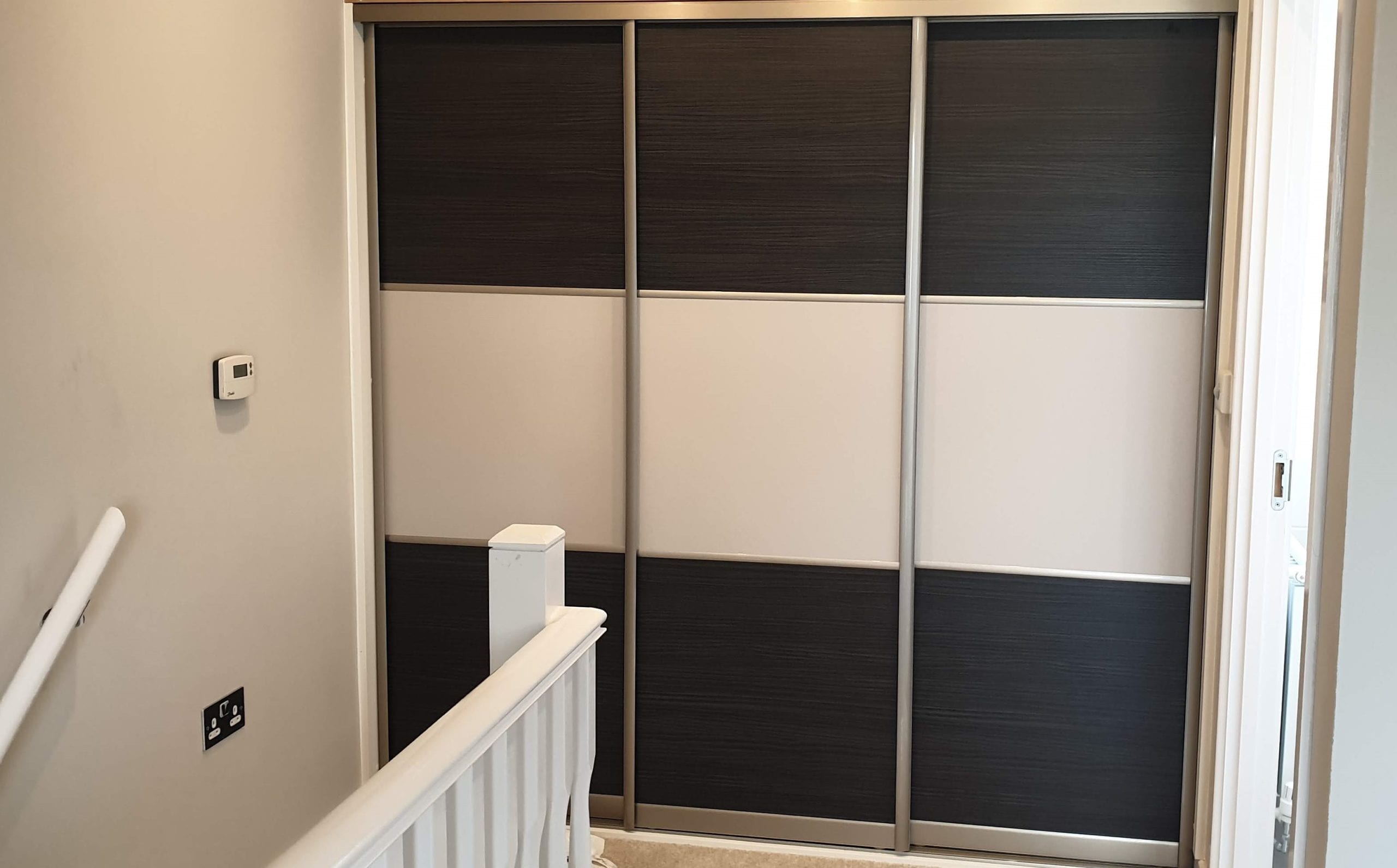 Sliding door wardrobe for the bedroom with sloped ceilng