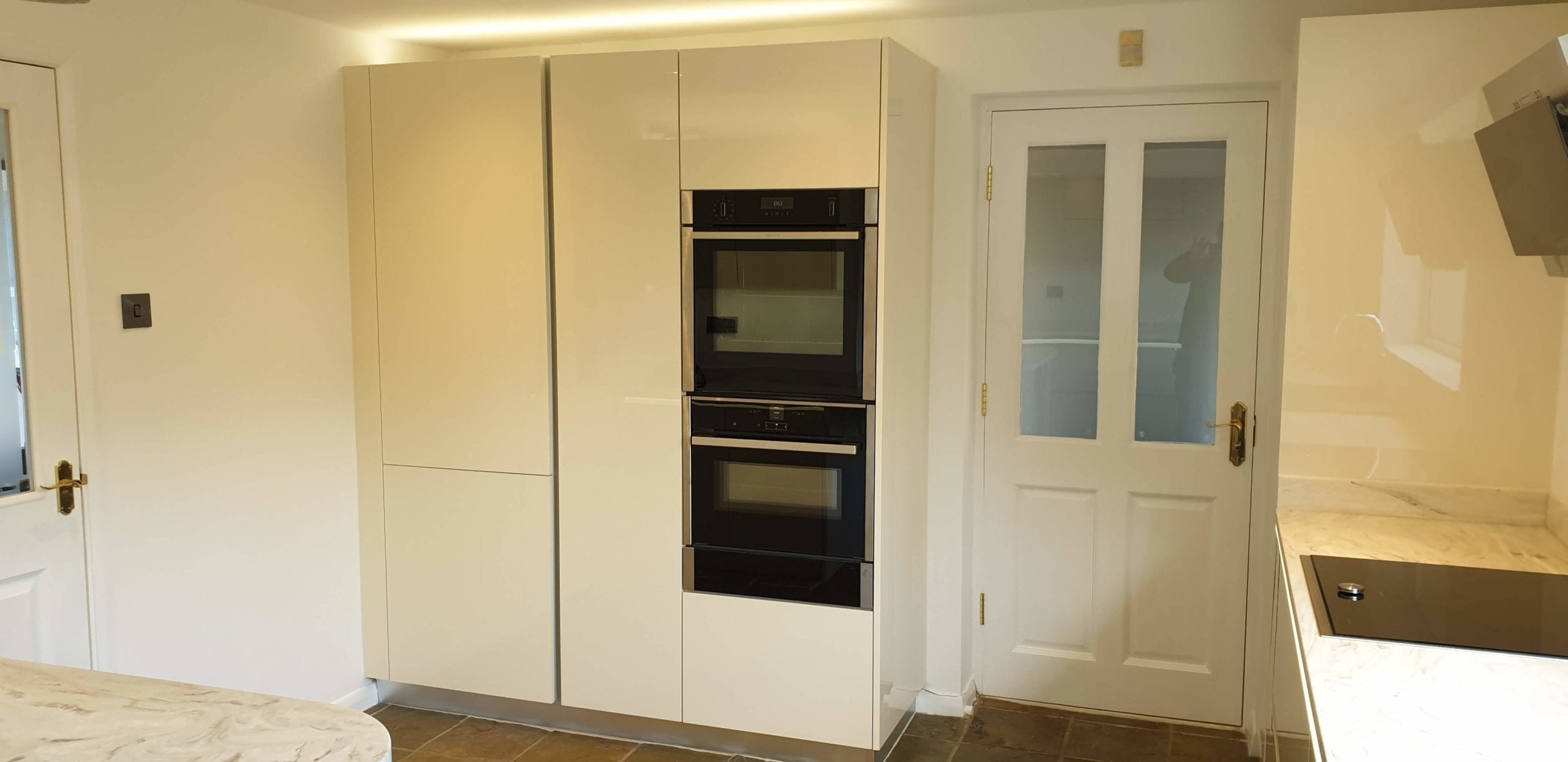 High gloss ivory handleless fitted kitchen Otley Fitted Kitchens Otley