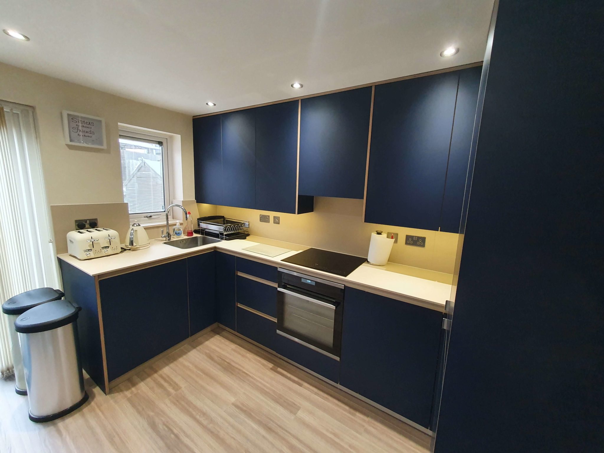 U-shape dark blue ktichen.